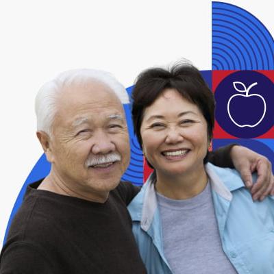 An older couple hug and smile.